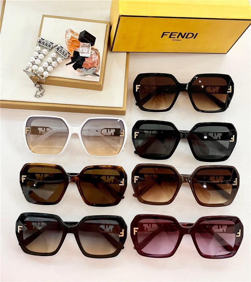 Assorted oversized Fendi sunglasses with square frames in various colors, displayed with accessories.