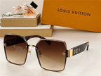 Oversized square sunglasses with gradient brown lenses and gold accents, displayed with designer packaging.