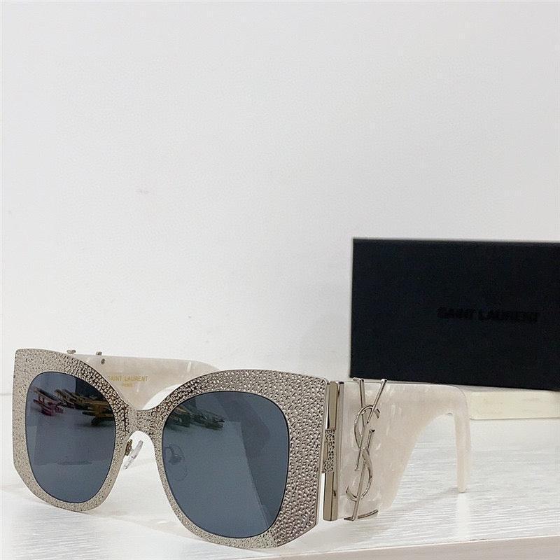 Oversized square sunglasses with crystal-studded frames and dark lenses on white surface
