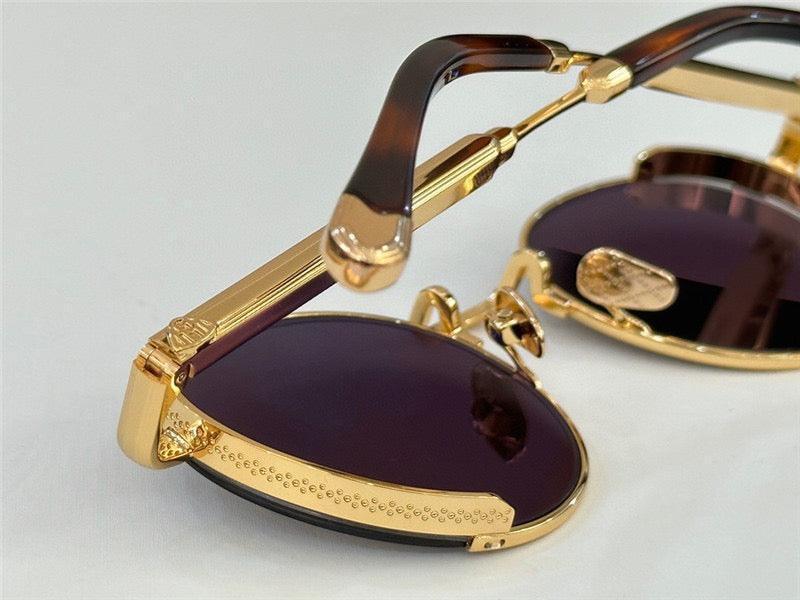 Close-up of luxury gold frame sunglasses with dark lenses and tortoiseshell arms