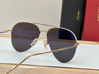 Gold aviator sunglasses with dark polarized lenses and UV protection on a table