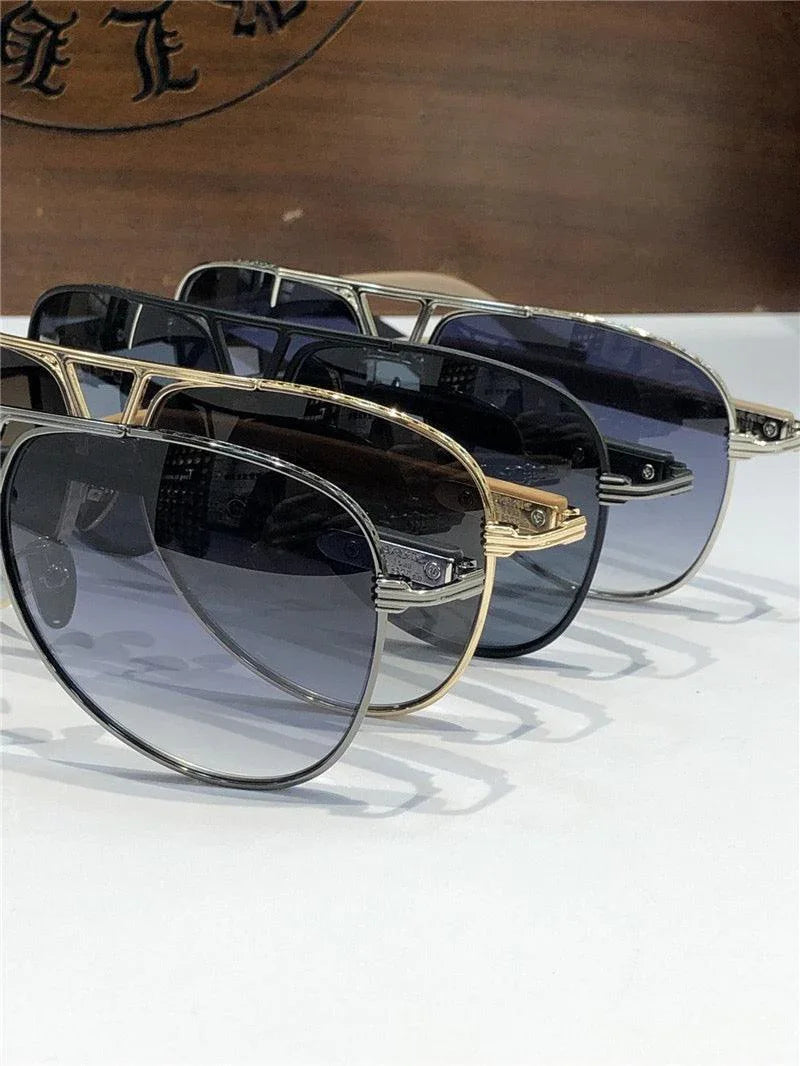 Three pairs of aviator sunglasses with gradient lenses and metal frames on display.