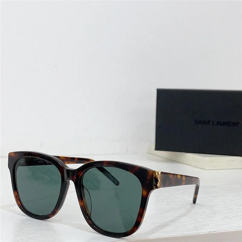 Tortoise shell square sunglasses with dark polarized lenses on a white surface