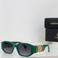 Green square-frame sunglasses with gold decorative accents and dark lenses on white surface