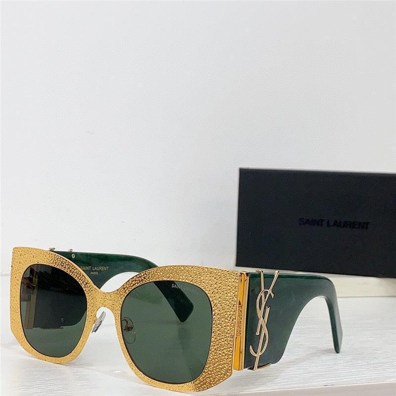 Gold textured oversized square sunglasses with green lenses and designer logo on temple