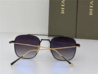 Black and gold square sunglasses with gradient lenses on white surface, two boxes in background