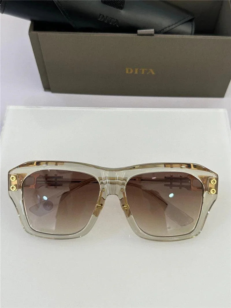 Transparent square sunglasses with gold accents and gradient brown lenses on display