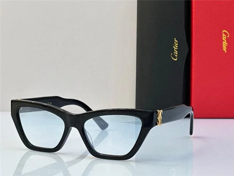 Black cat-eye sunglasses with light blue lenses and gold temple accents on a white surface
