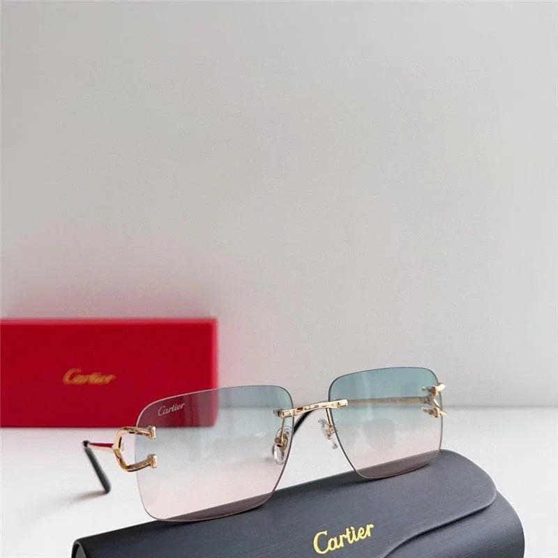 Elegant rimless gradient sunglasses with gold temples displayed on a case and red box.