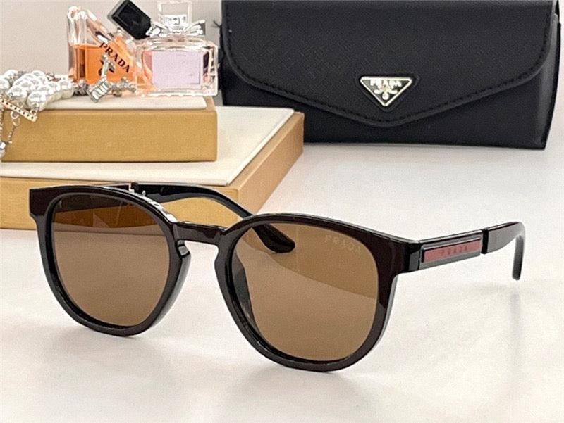 Designer black sunglasses with brown polarized lenses on a table, luxury accessories in background