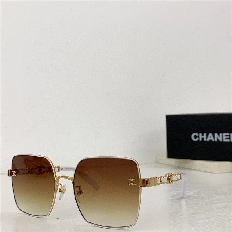 Square oversized sunglasses with gold frames and brown gradient lenses on white surface