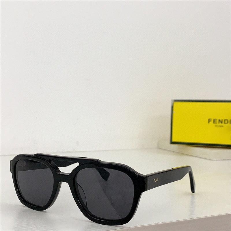 Black designer sunglasses with thick frame and dark lenses on a white surface