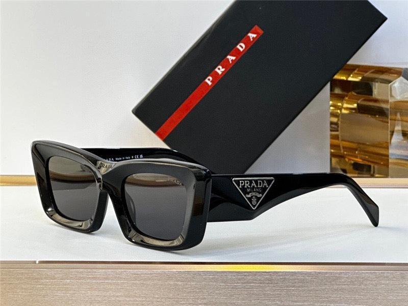 Black Prada rectangular sunglasses with thick frames and logo, displayed with branded case