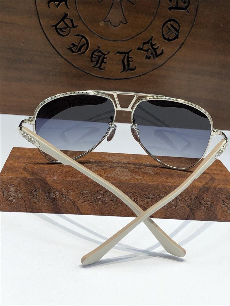 Stylish aviator sunglasses with silver frames and gradient lenses on a wooden display.