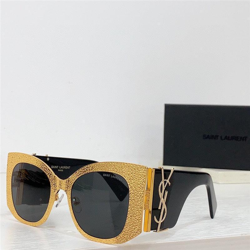 Gold textured oversized sunglasses with black lenses and bold black arms, luxury accessory