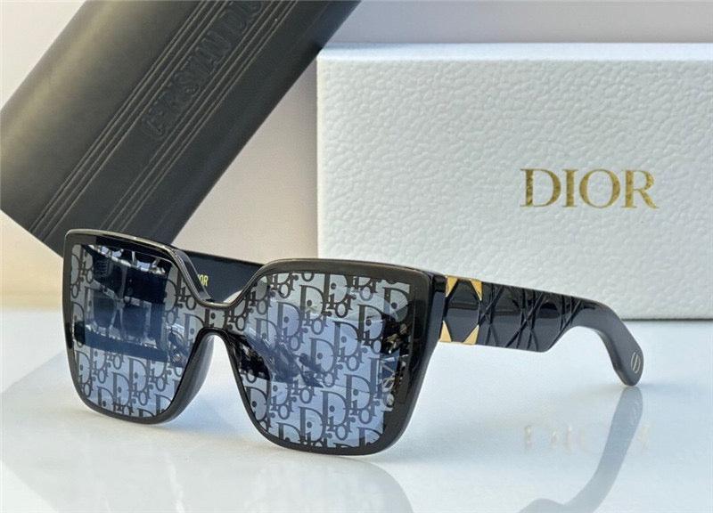 Oversized square sunglasses with patterned lenses and black and gold frame, displayed with case