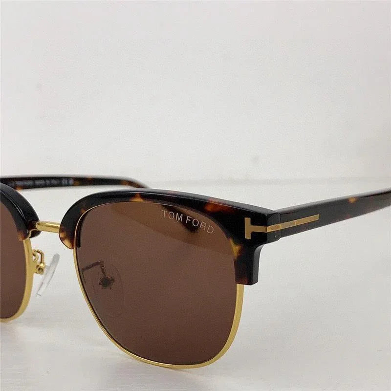 Tortoiseshell clubmaster sunglasses with gold accents and brown polarized lenses