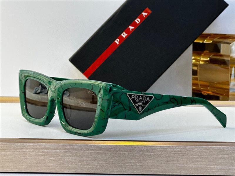 Green square sunglasses with marble pattern, Prada logo detail, and dark lenses on display.