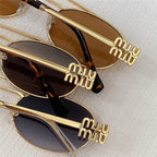 Three pairs of oval sunglasses with gold temples and brown tinted lenses on white textured surface