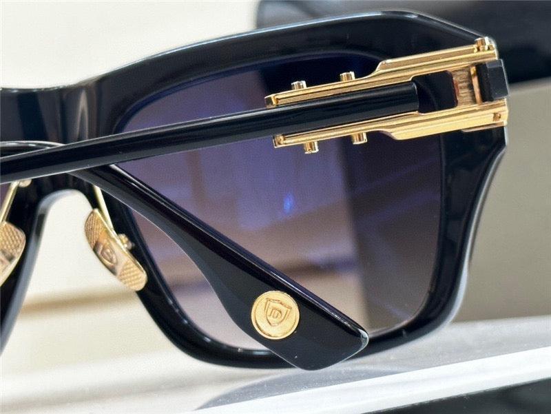 Close-up of luxury sunglasses with black frames, gold accents, and tinted lenses