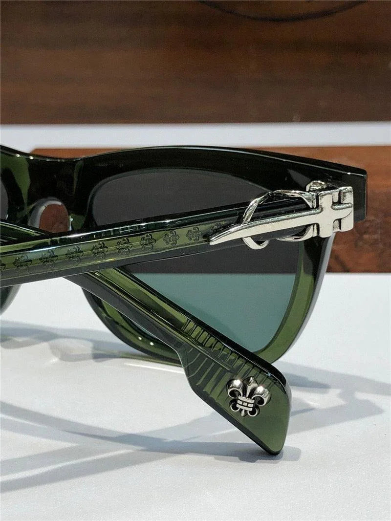 Green acetate sunglasses with silver fleur-de-lis detail and temple hinge accents