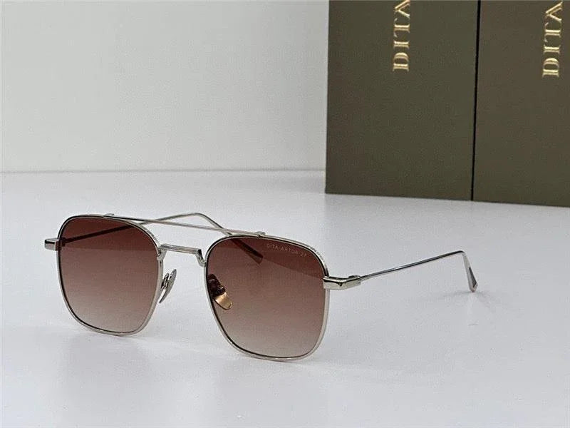 Square aviator sunglasses with brown gradient lenses and thin metal frame on white surface