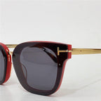 Square red sunglasses with gold metal arms and dark lenses, luxury eyewear closeup