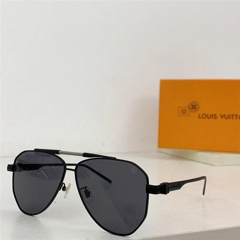 Black aviator sunglasses with dark polarized lenses on a white surface, orange box in background
