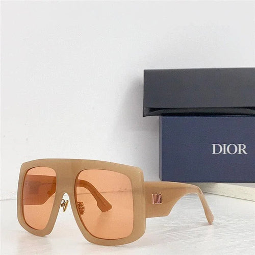 Beige oversized square sunglasses with pink lenses, designer case in background.