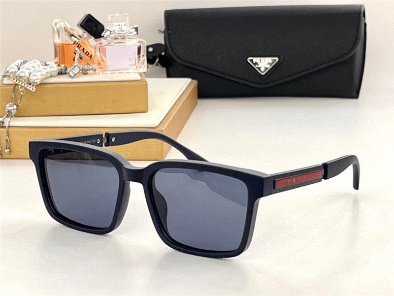 Black square sunglasses with dark lenses, luxury case, jewelry, and perfume in background
