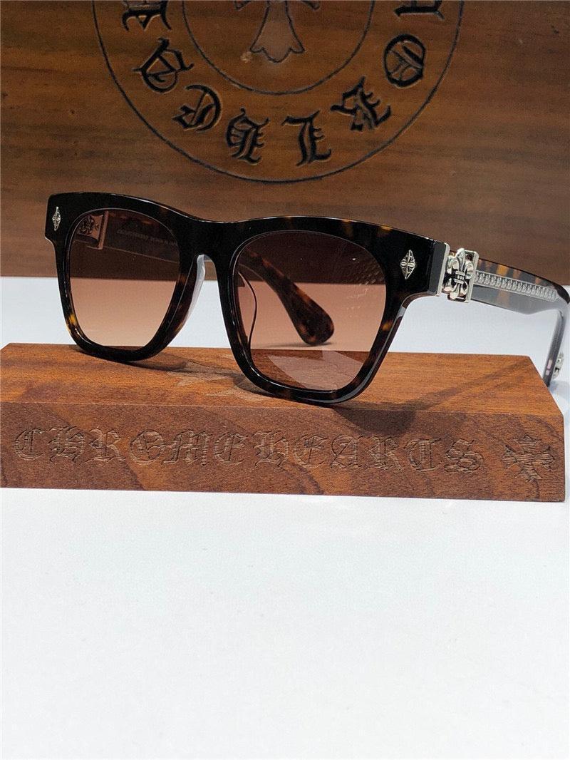 Tortoiseshell square sunglasses with brown gradient lenses and silver temple detail on display stand