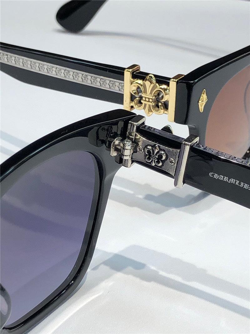 Black sunglasses with gold and silver fleur-de-lis temple details and tinted lenses