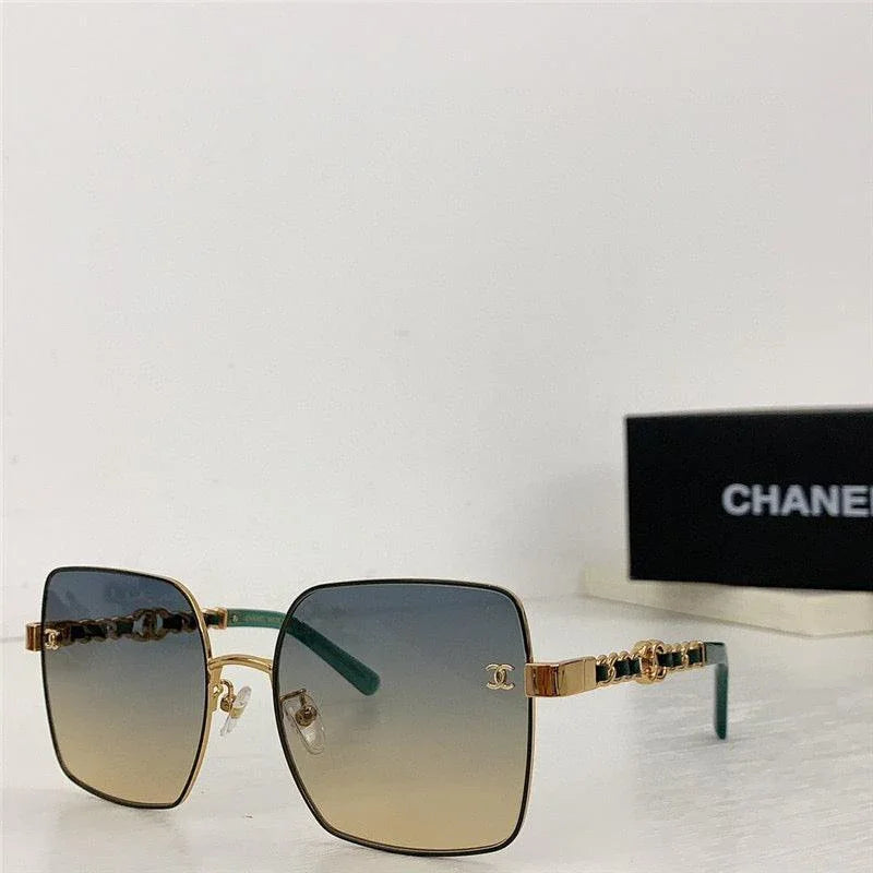 Square oversized sunglasses with gold frame and gradient lenses on white background