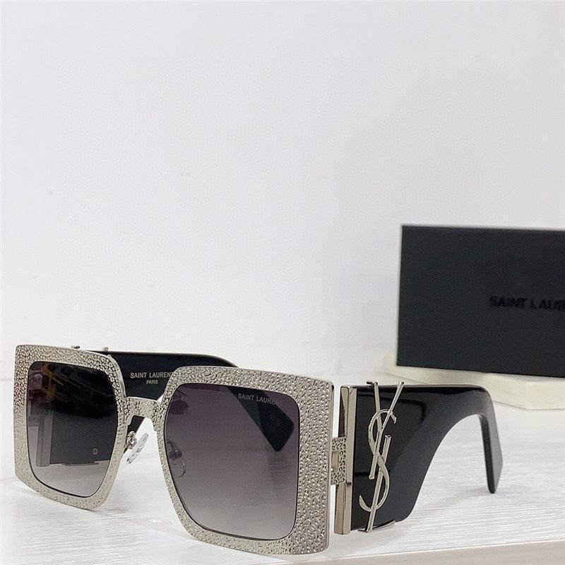 Square oversized sunglasses with rhinestone-encrusted frames and gradient lenses on table
